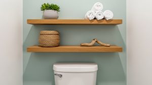 Utilizing vertical space above the toilet is one of the most effective tiny bathroom organization hacks.