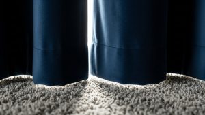 Heavy curtains and rugs are essential soft materials when figuring out how to soundproof a room cheaply.