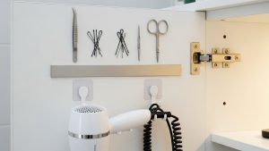 Using cabinet doors for storage is a clever, hidden tiny bathroom organization hack.